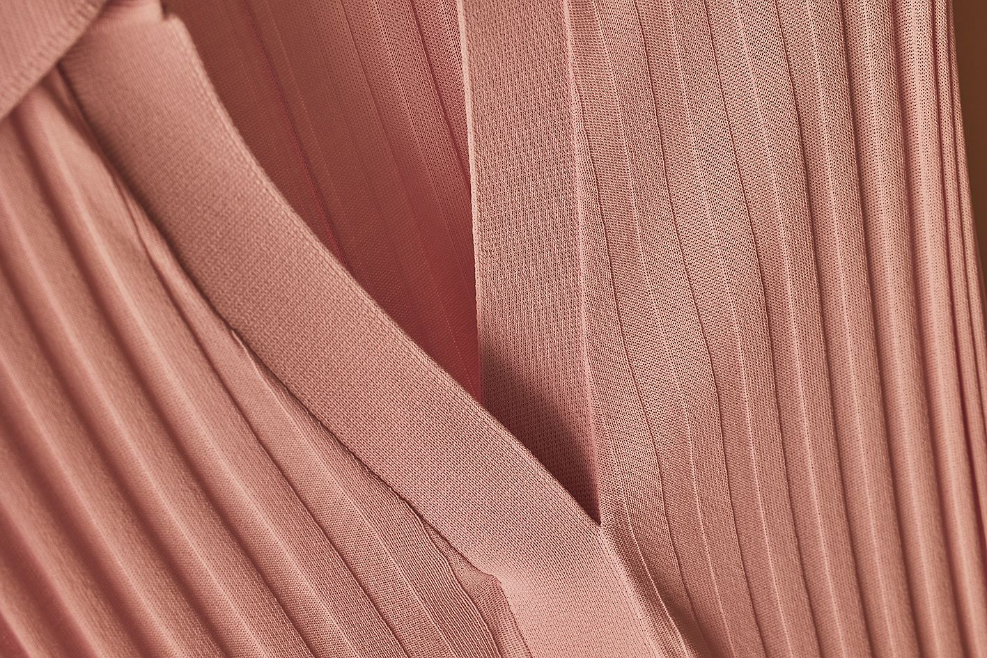 Scanlan Theodore pleated rib dress with close detailed view of knitted fabrication and v-neckline collar.