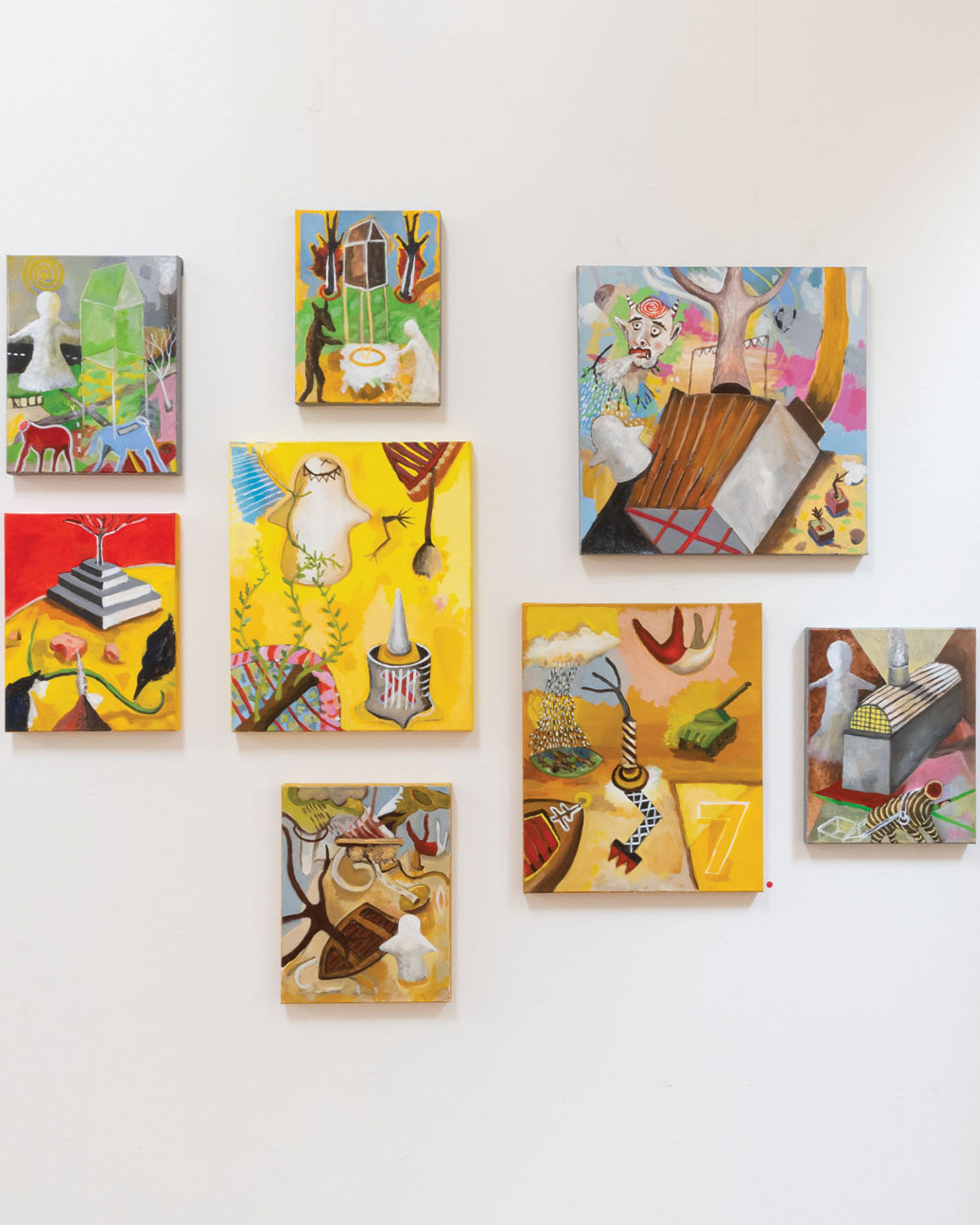 Gallery wall of brightly coloured surrealist paintings