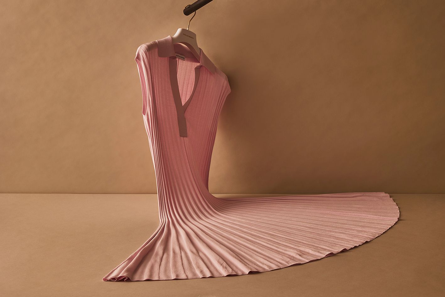Scanlan Theodore pink pleated rib dress hanging in a fanned formation.