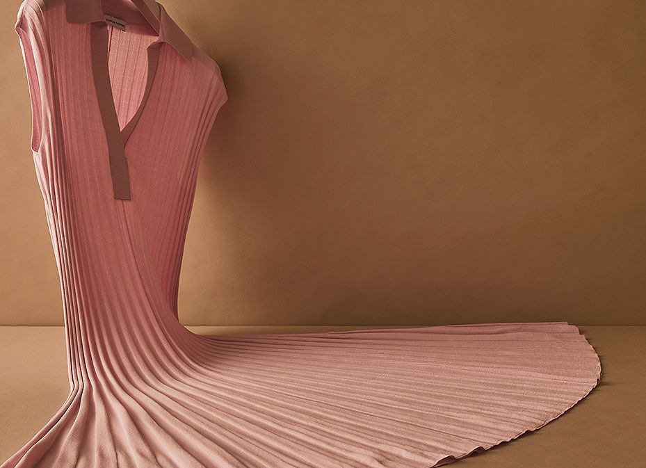 Scanlan Theodore pink pleated rib dress hanging in a fanned formation.