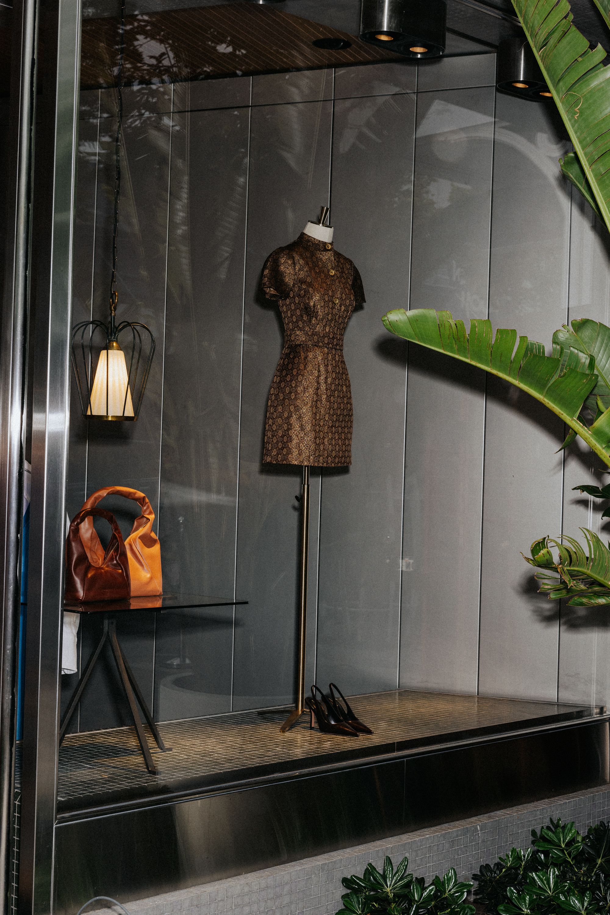 Window display at night with Gold French Brocade Button Dress on mannequin