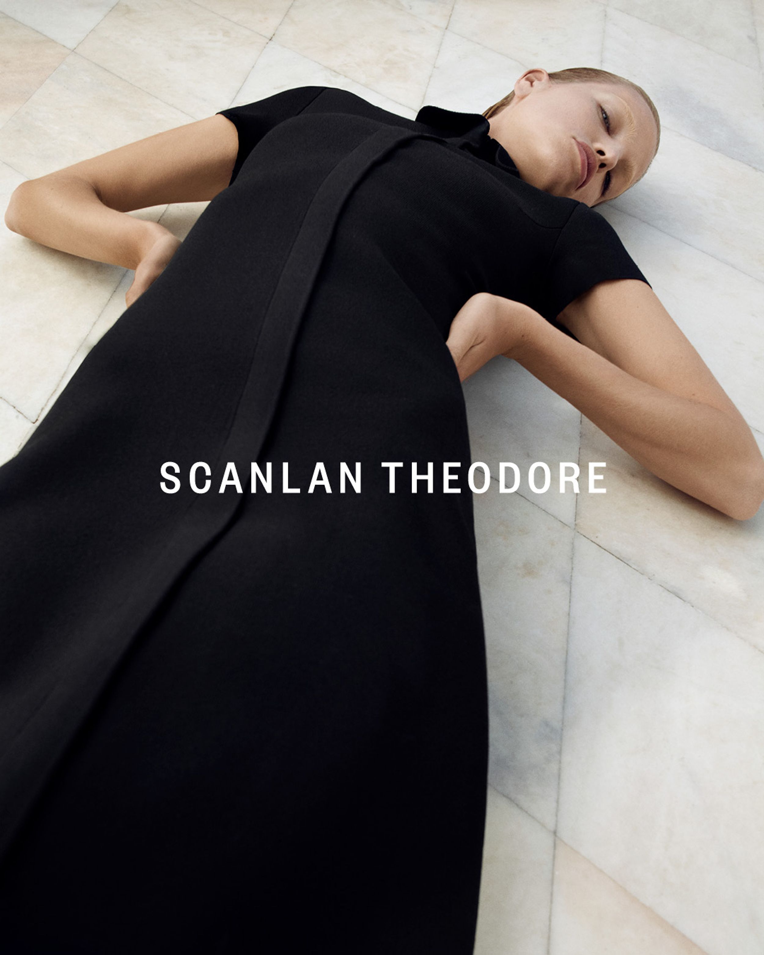 Blonde model lying down in Black Crepe Knit Zip Shirt Dress - Winter 2023 Part 2