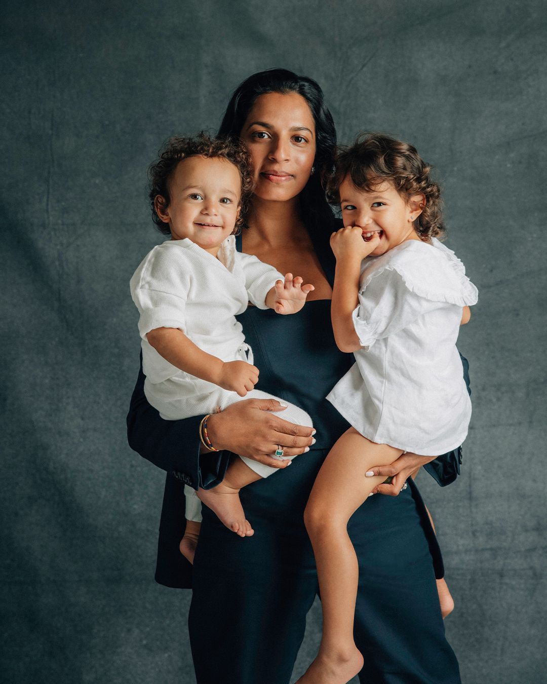 Shamini Rajarethnam standing holding her two toddlers
