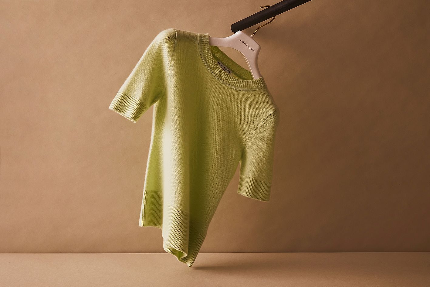 Scanlan Theodore cashmere top with short sleeves hanging on a rail.