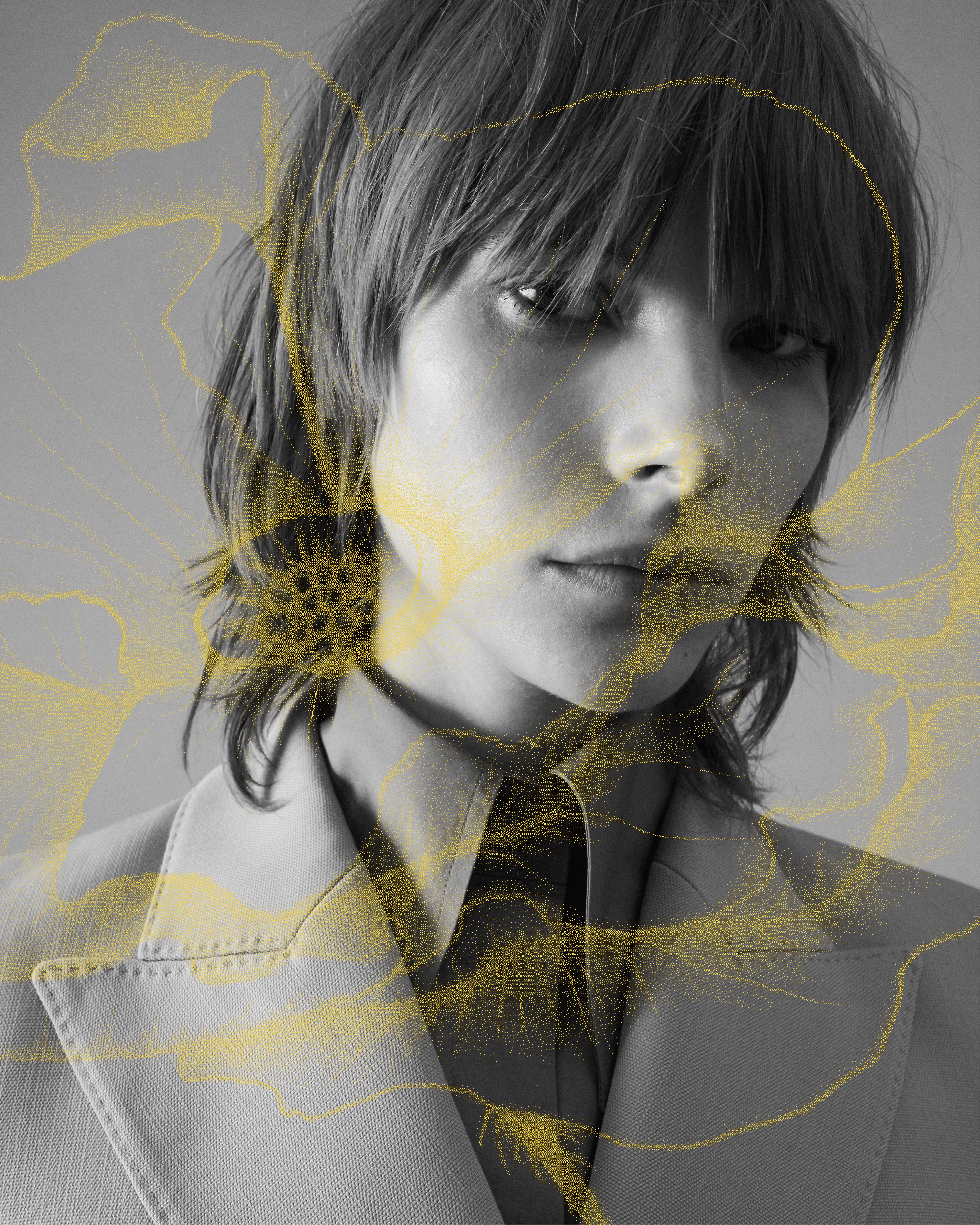 Black and white image of close up of model's face with yellow poppy illustration overlaid on top