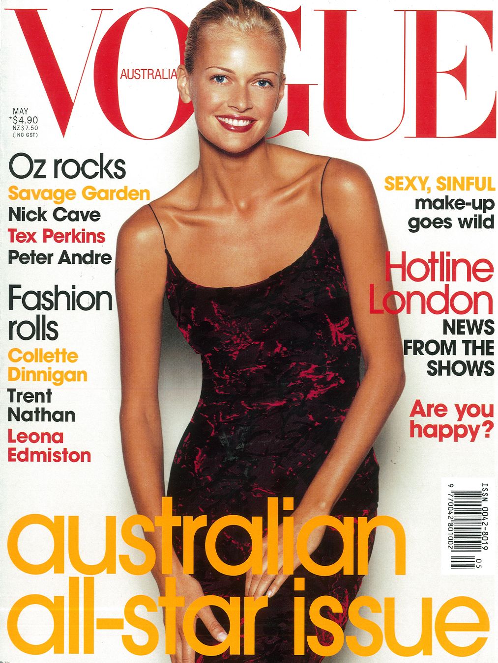 Vogue Australia magazine cover with Sarah Murdoch smiling with a sleek bun wearing a black and red slip dress