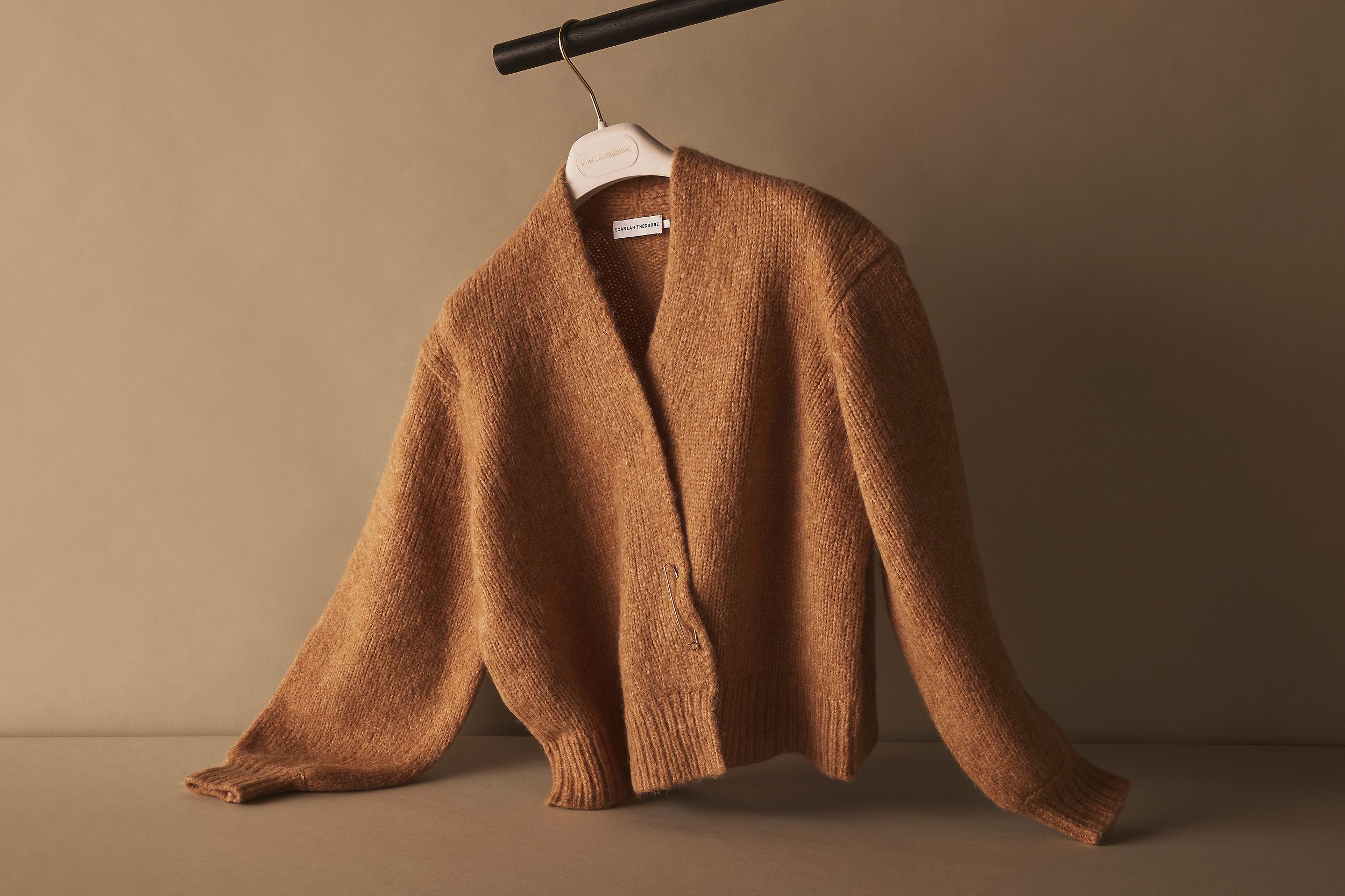 Scanlan Theodore alpaca wrap cardigan hanging on a rail with relaxed styling. 