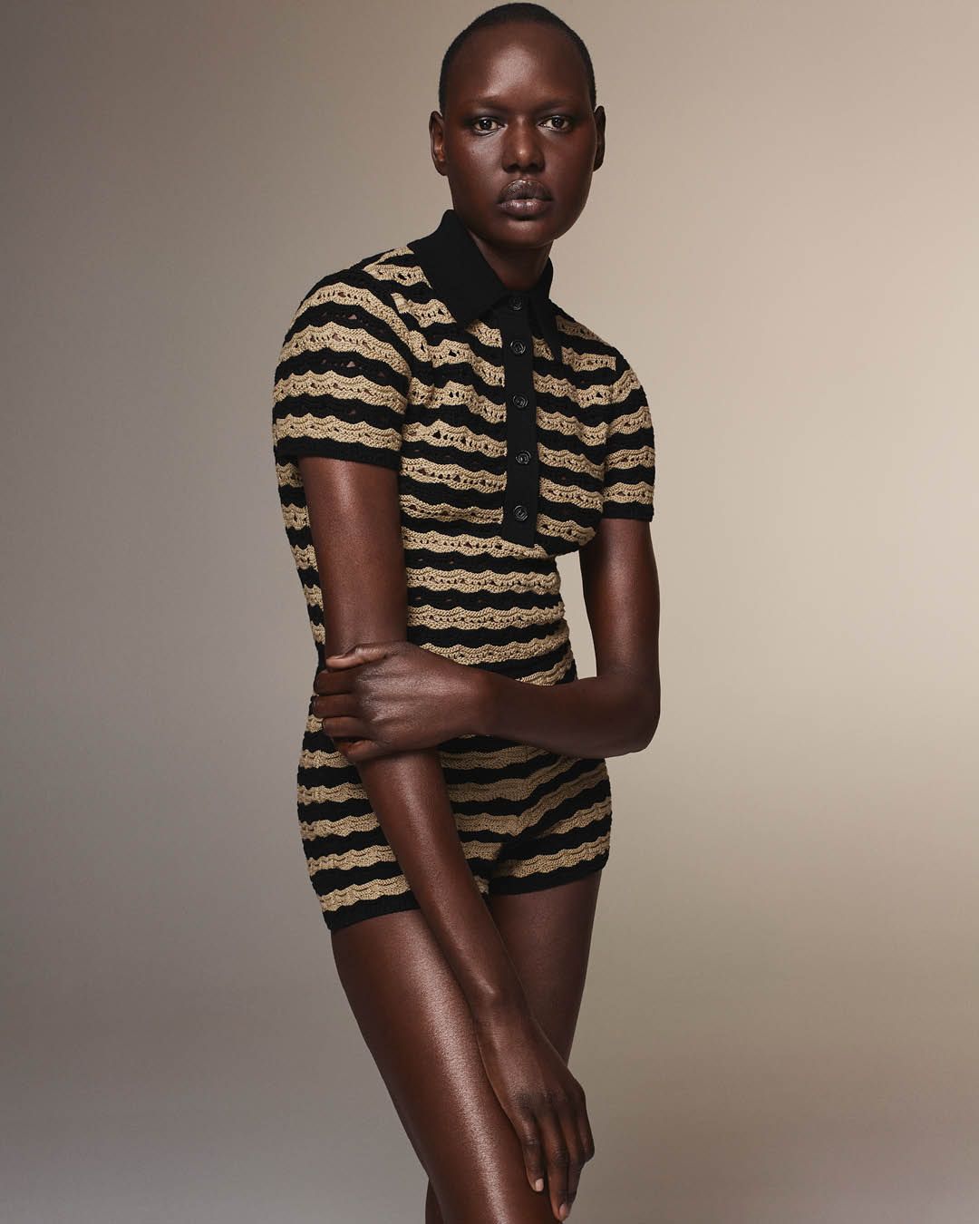 Ajak Deng wearing a matching black and beige crochet polo and hotpants