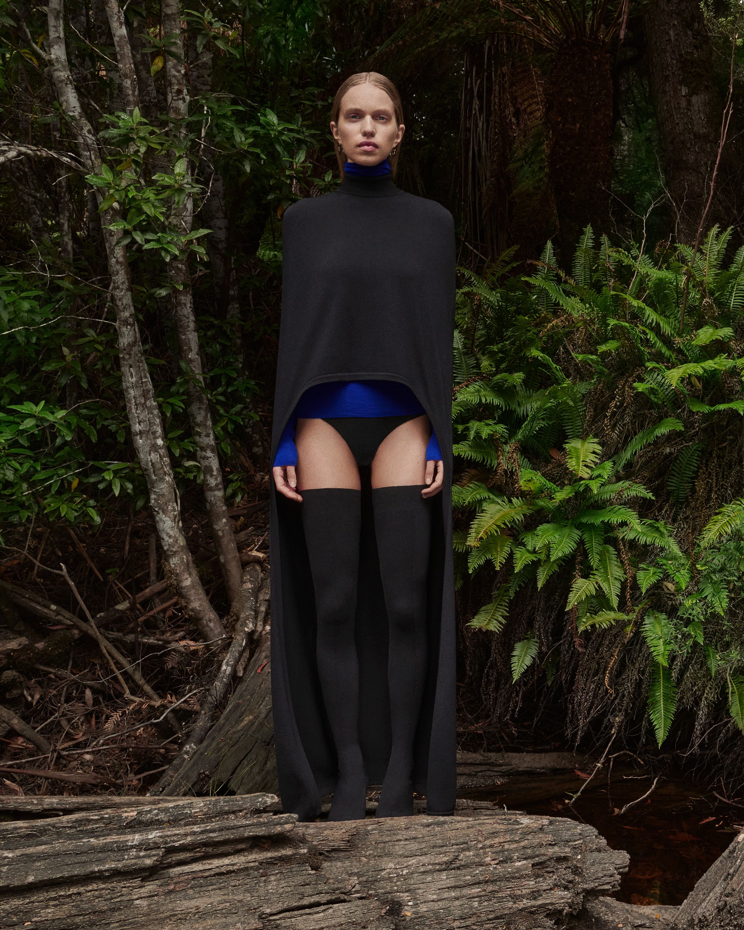 Sabine Glud and Venus He standing in the forest wearing Crepe Knit clothing in shades of black, camel and cobalt