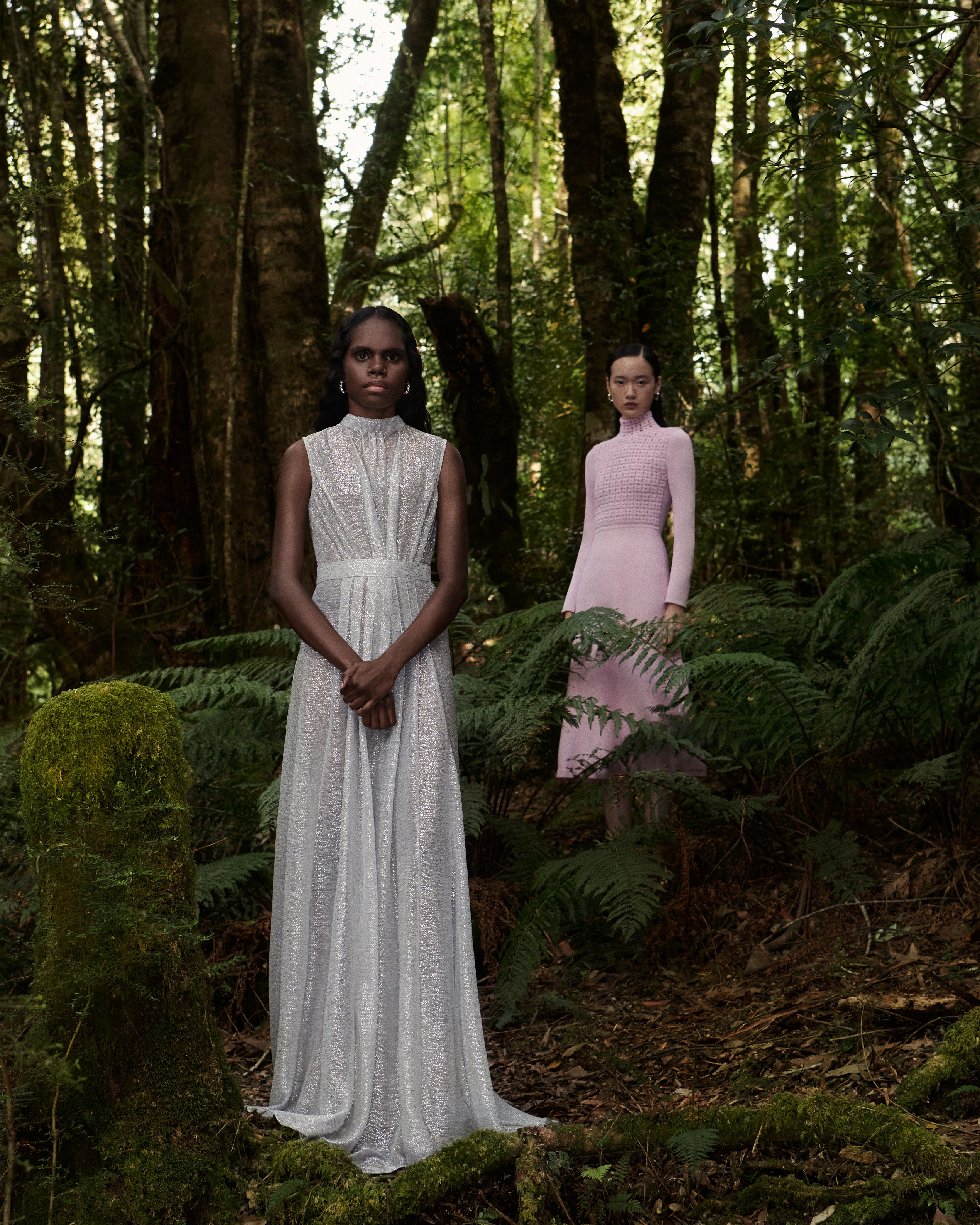 Tarlisa Gaykamangu and Venus He standing in the forest wearing a silver gown and pink dress