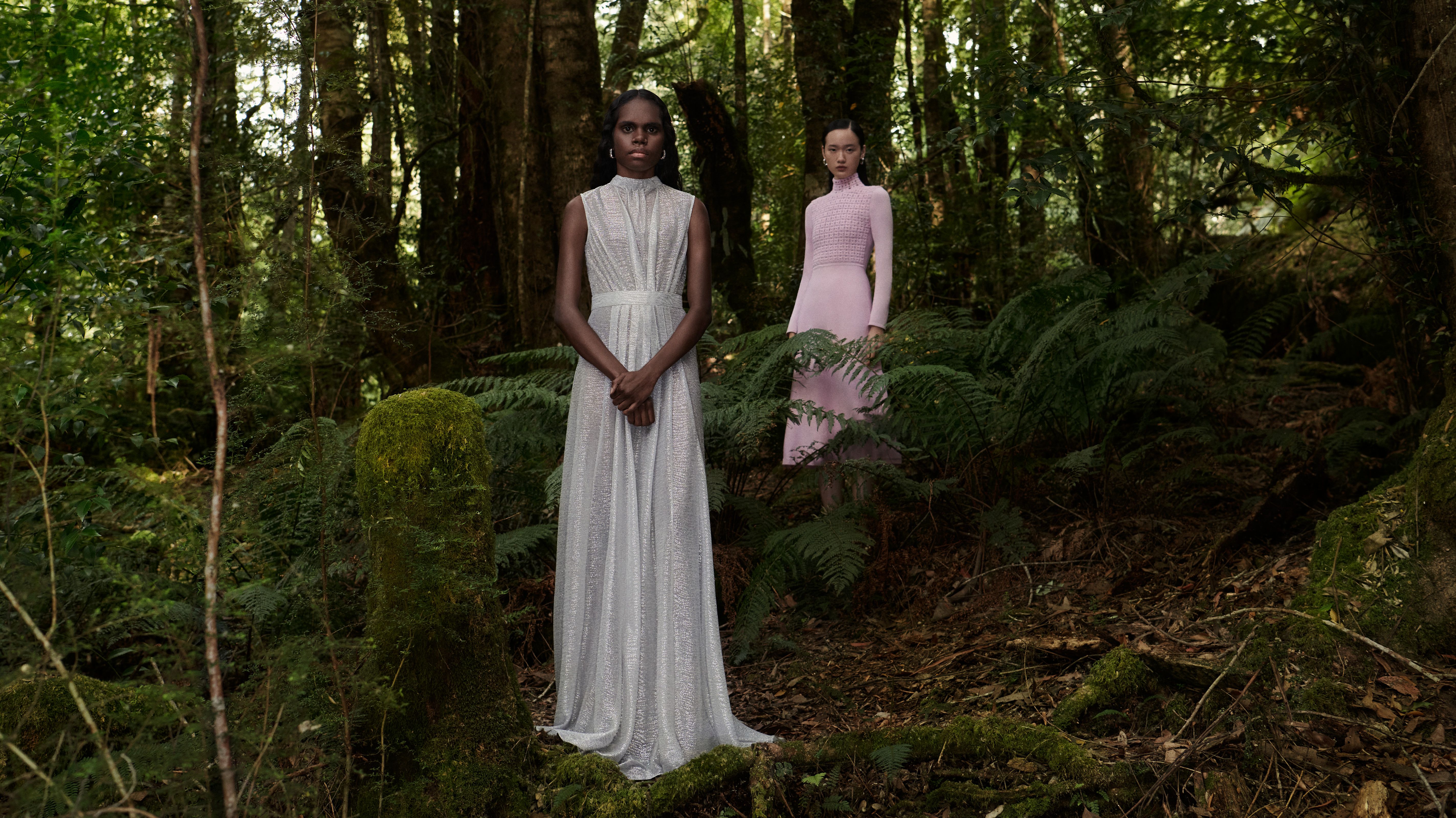 Tarlisa Gaykamangu and Venus He standing in the forest wearing a silver gown and pink dress