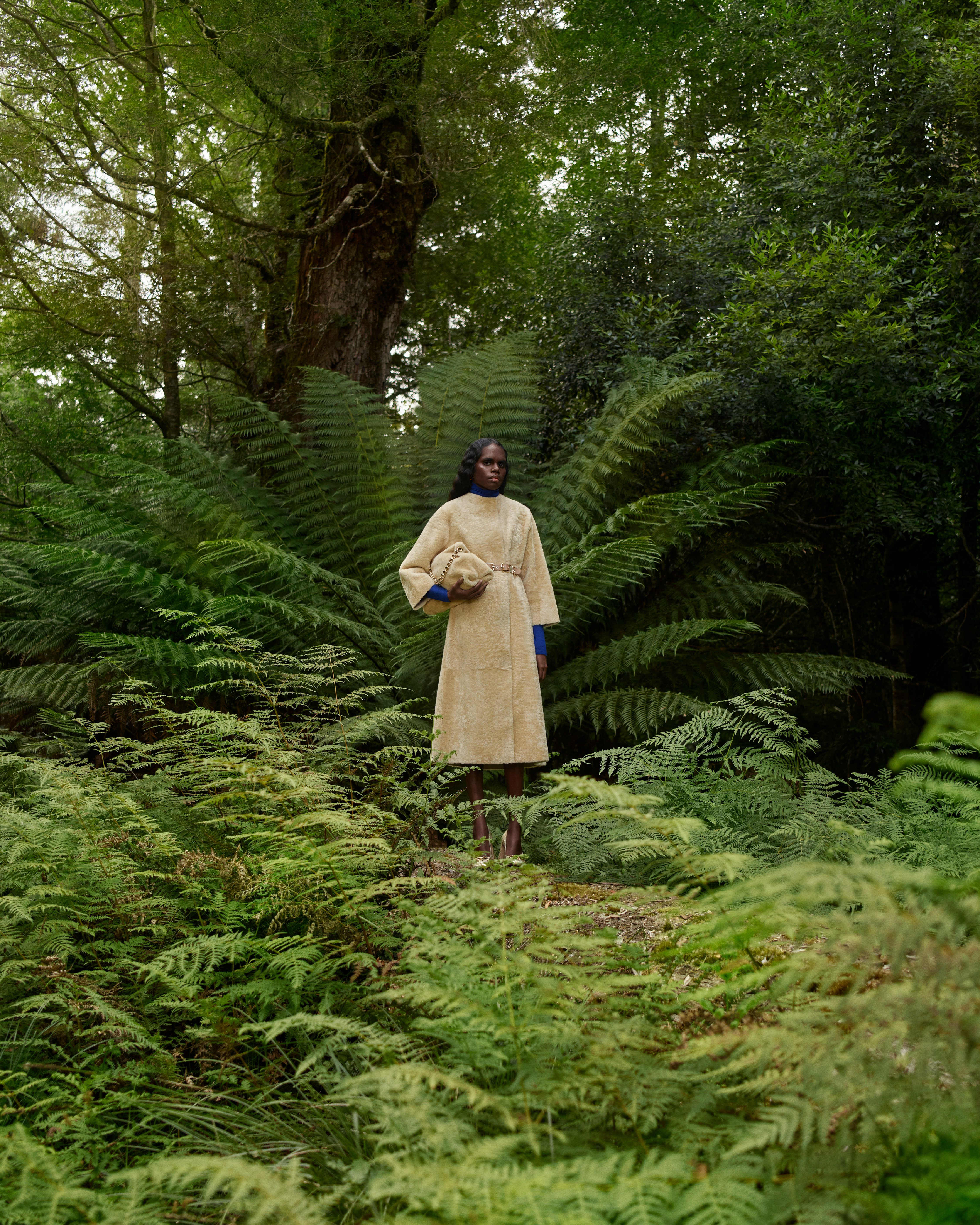 Tarlisa Gaykamangu standing in the forest wearing a yellow shearling coat