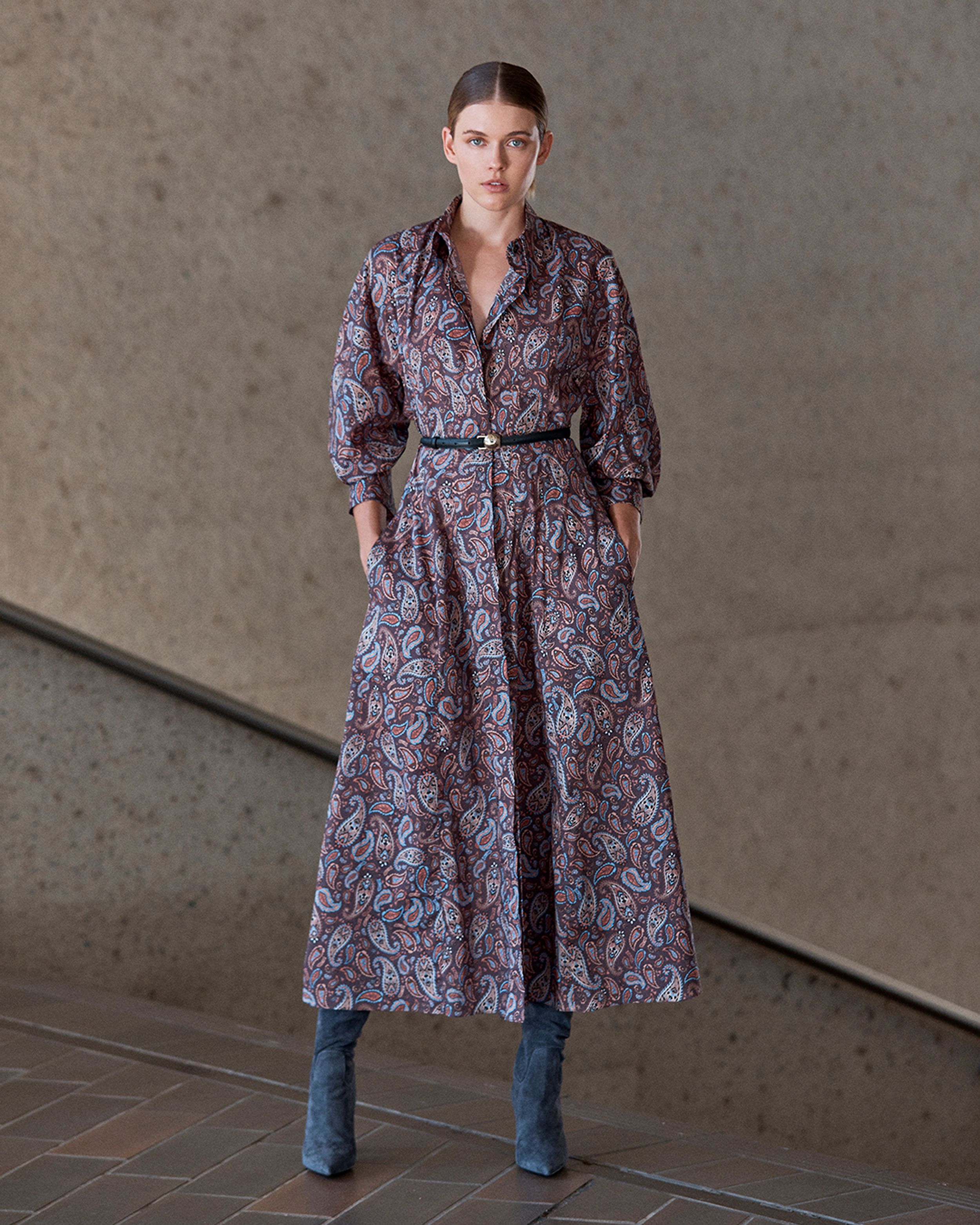 Model posing wearing a blue and purple midi shirt dress