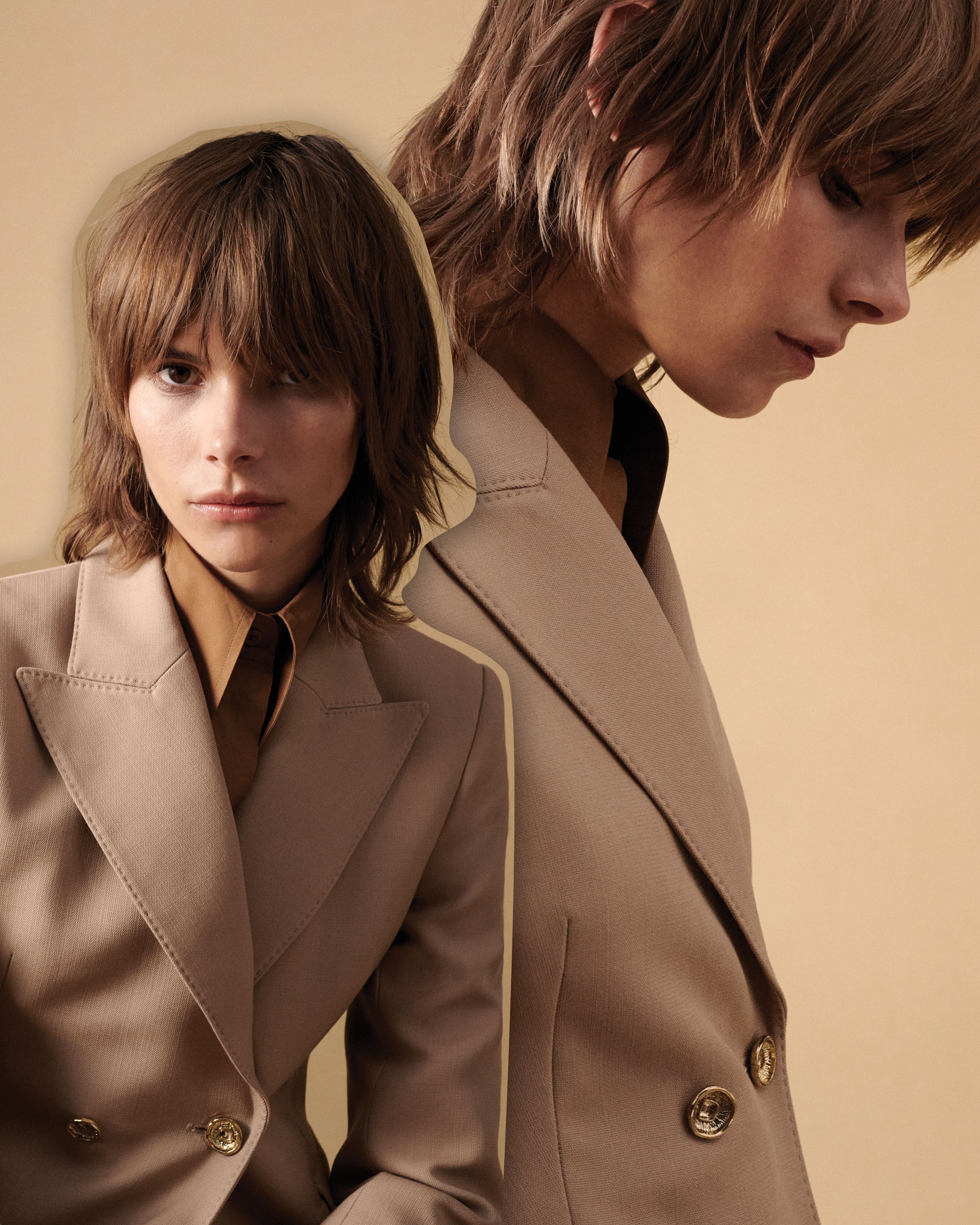 Model wearing a neutral toned jacket and shirt gazing at the camera