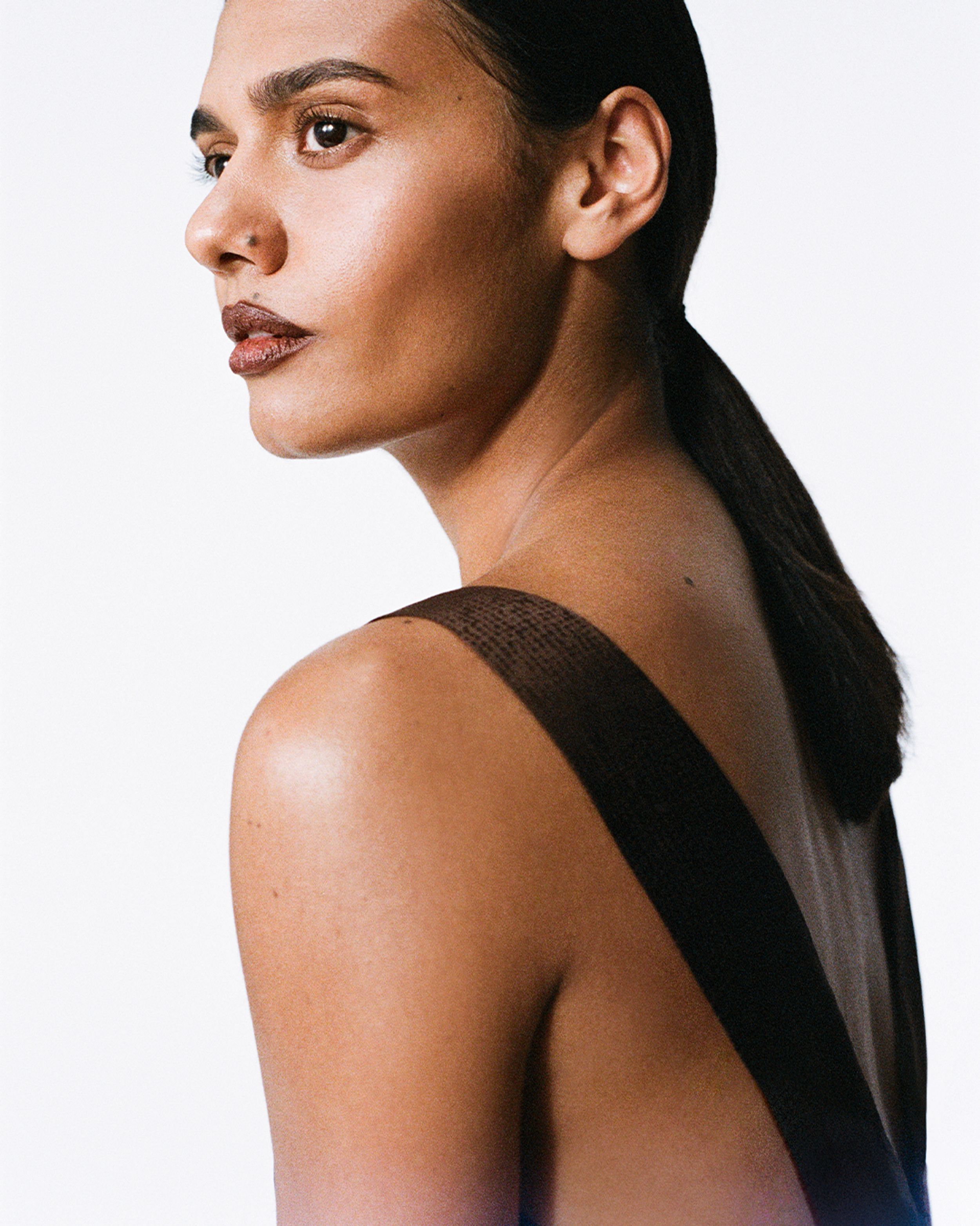 Madeleine Madden wearing a brown silk gown with deep v-backline