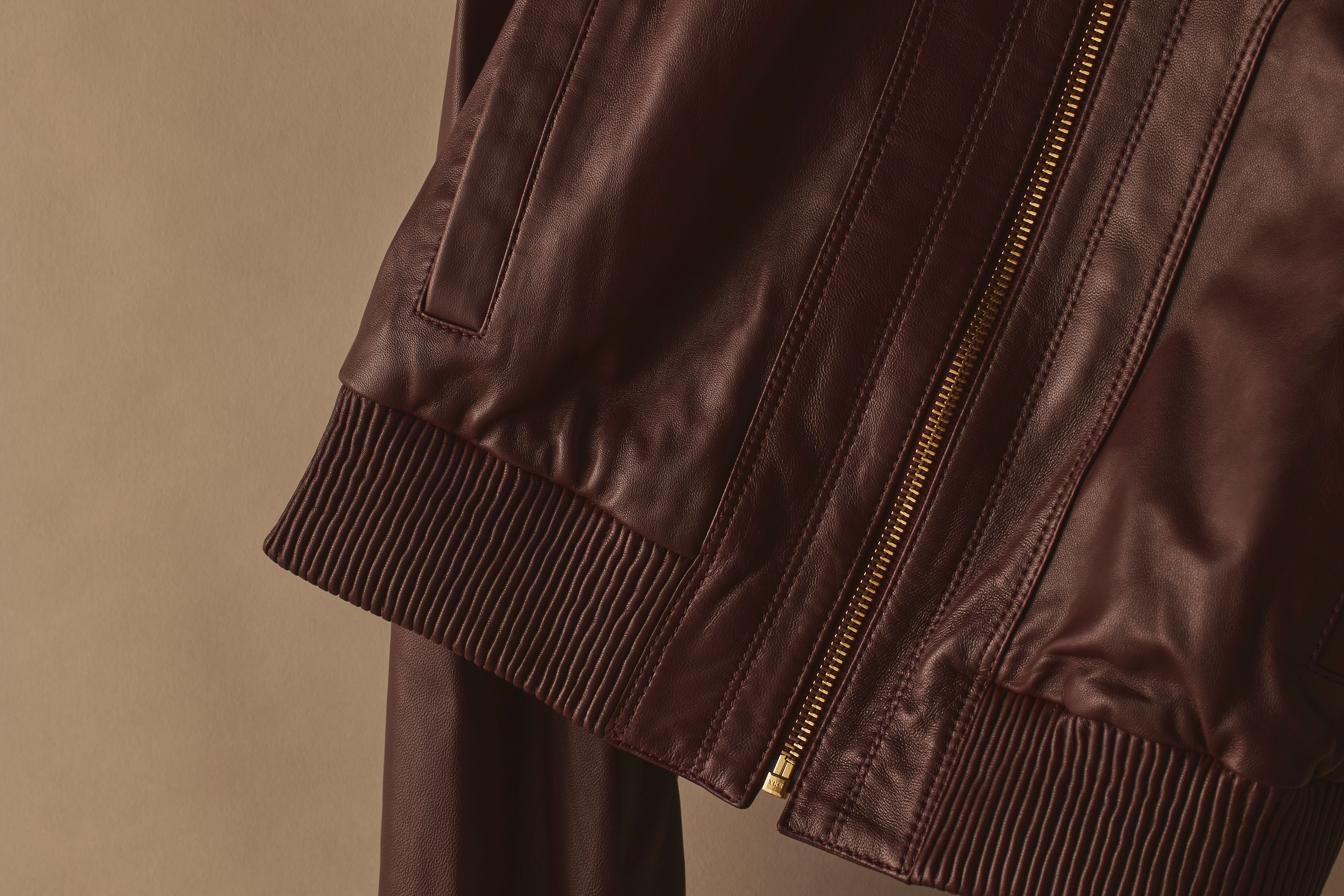Scanlan Theodore leather bomber jacket with detailed view of zipper and elasticated trim.