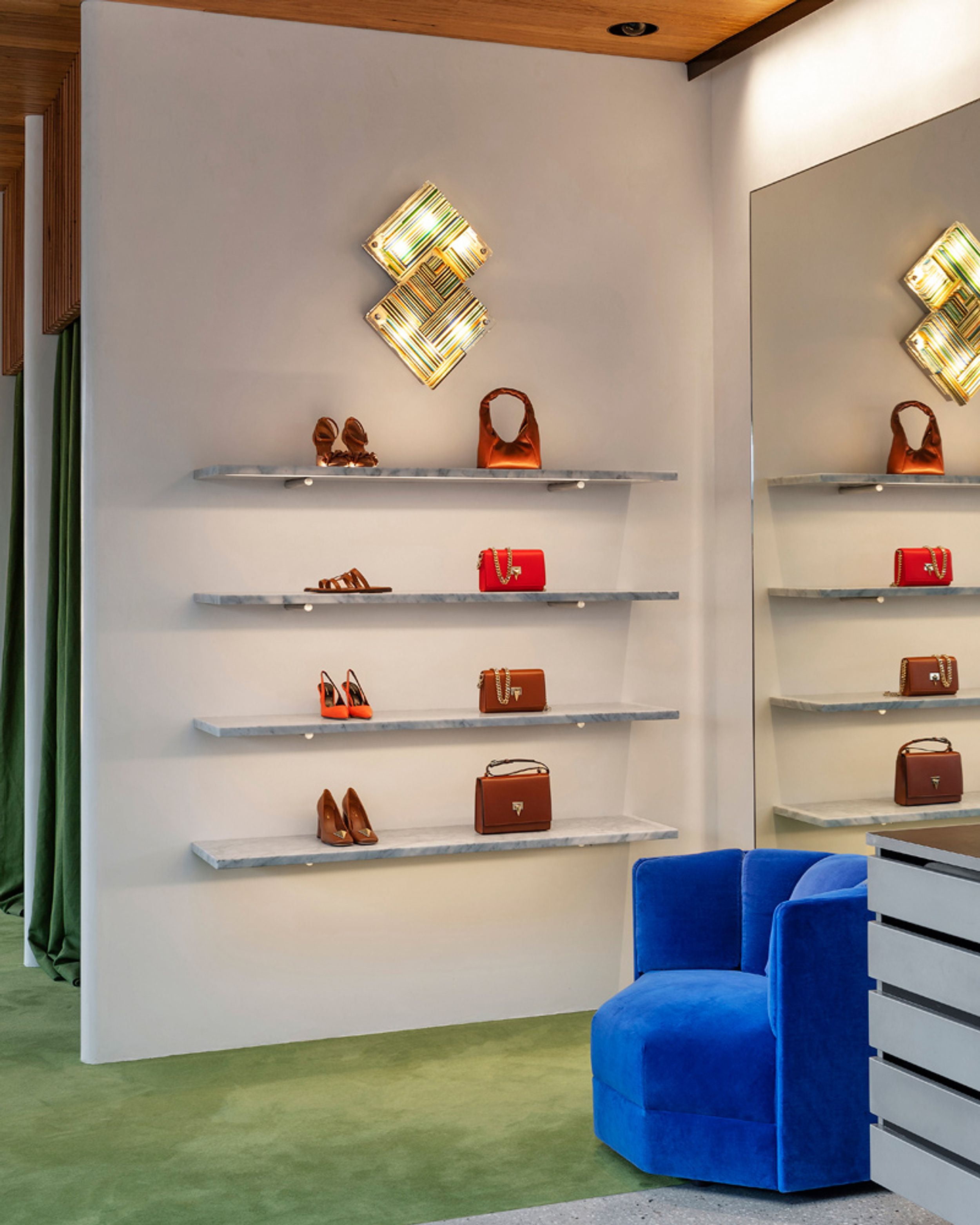 Store display shelves with bags and shoes in red and tan colours