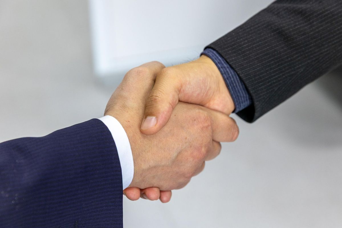Two people shaking hands after a business meeting
