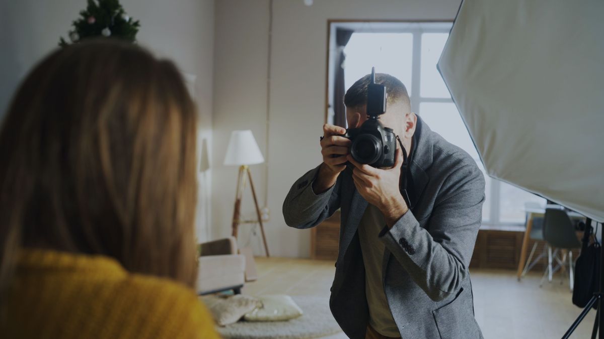 A photographer captures a portrait of an attendee at a headshot studio activation