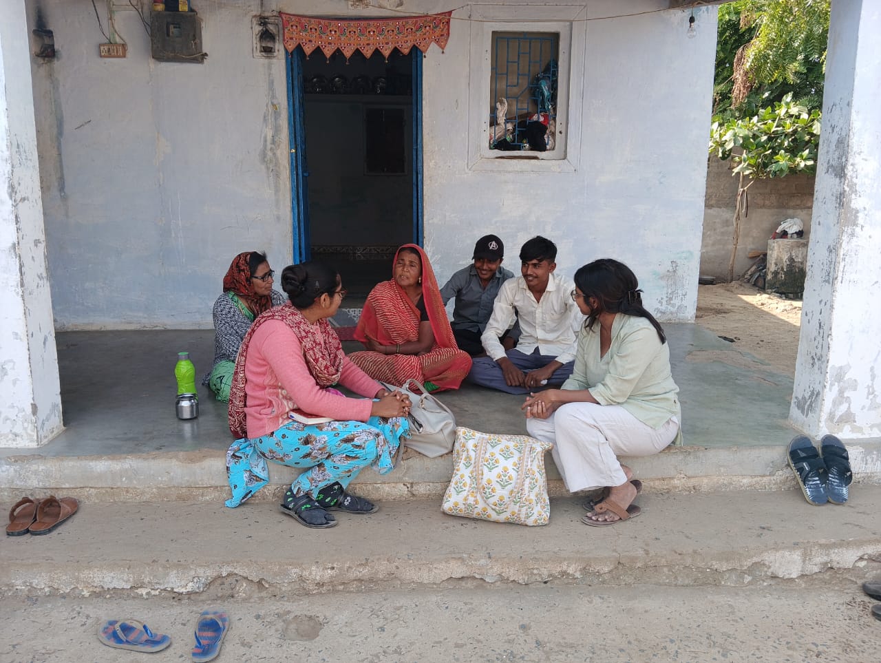 KMVS team in conversation with young boys in the community.