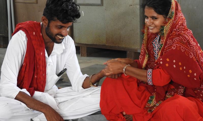 A man and woman sitting together and smiling