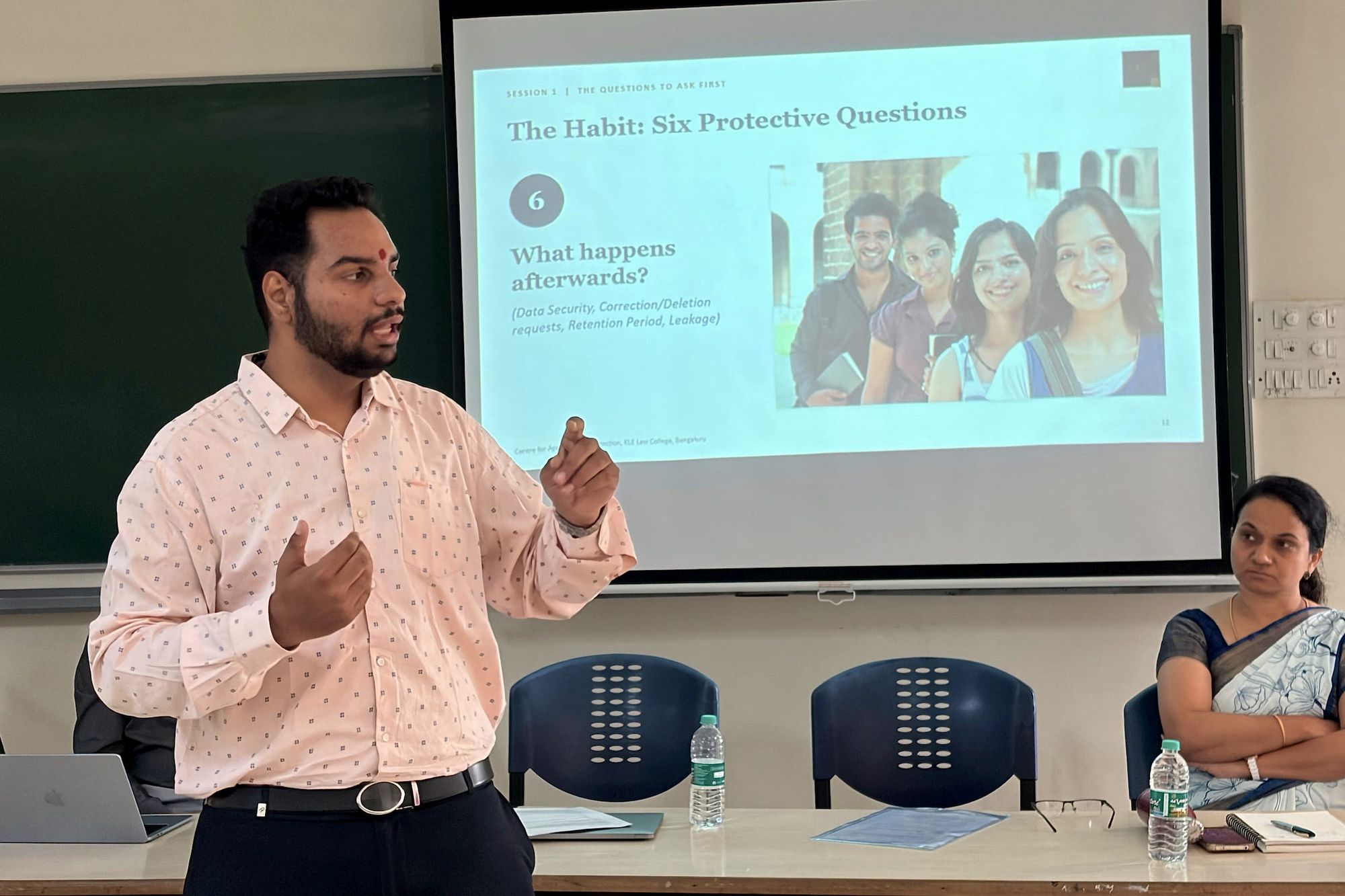 Mr. Shambhunath Yadiyapur speaks in front of a slide titled The Habit: Six Protective Questions.