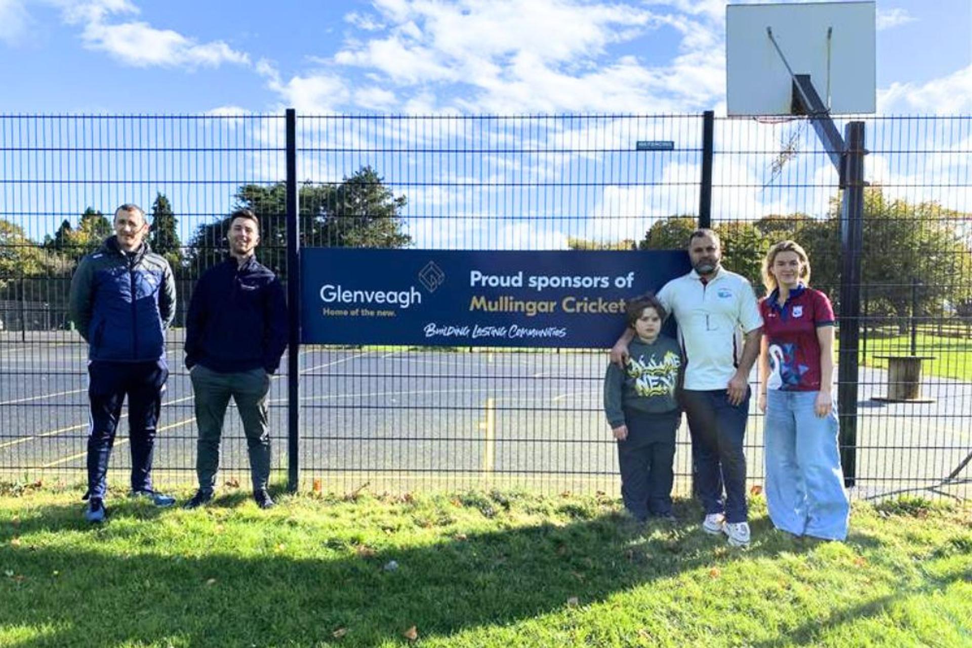 people in front of Glenveagh signage at cricket pitch