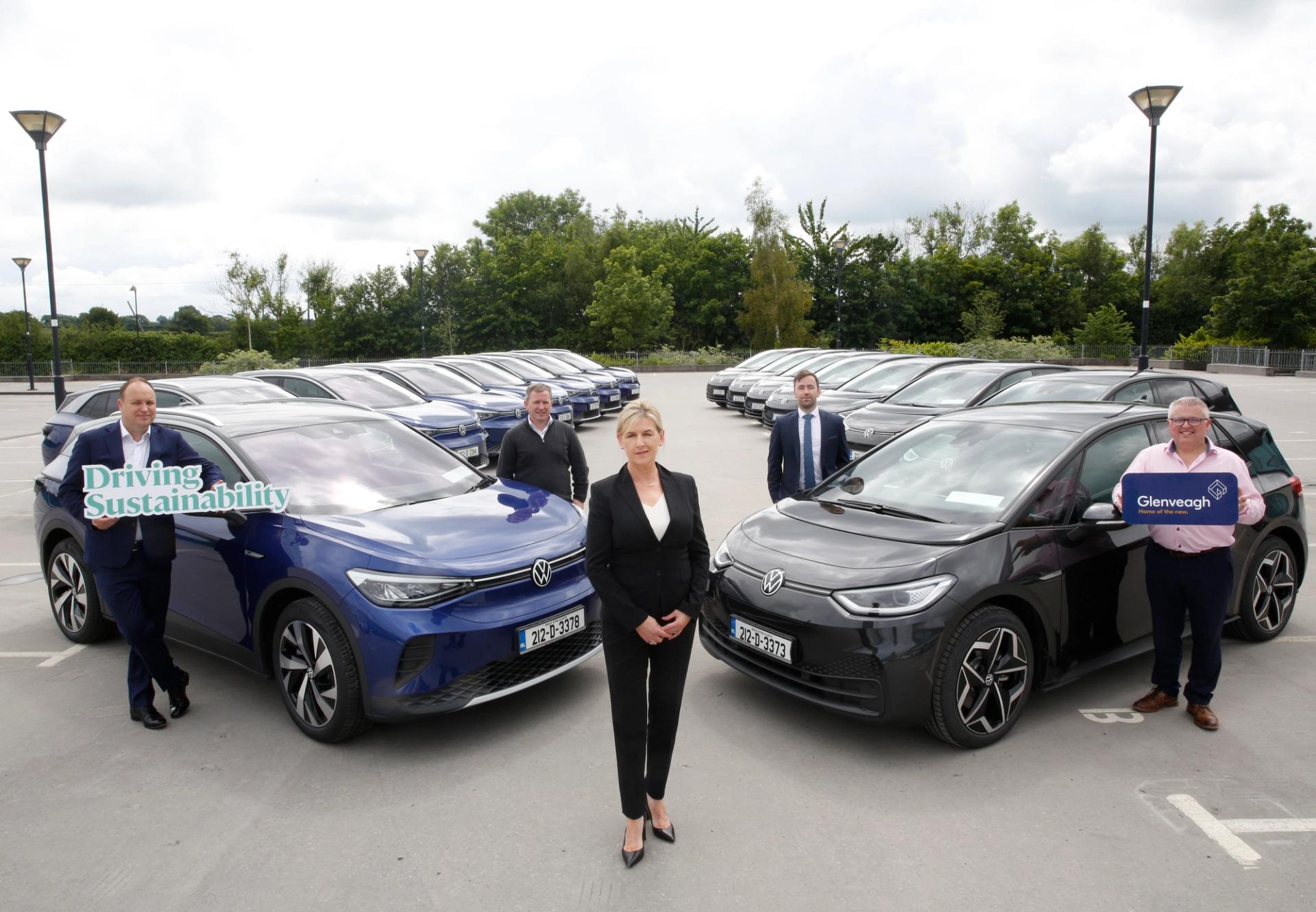 Glenveagh management team standing in front of new EV fleet