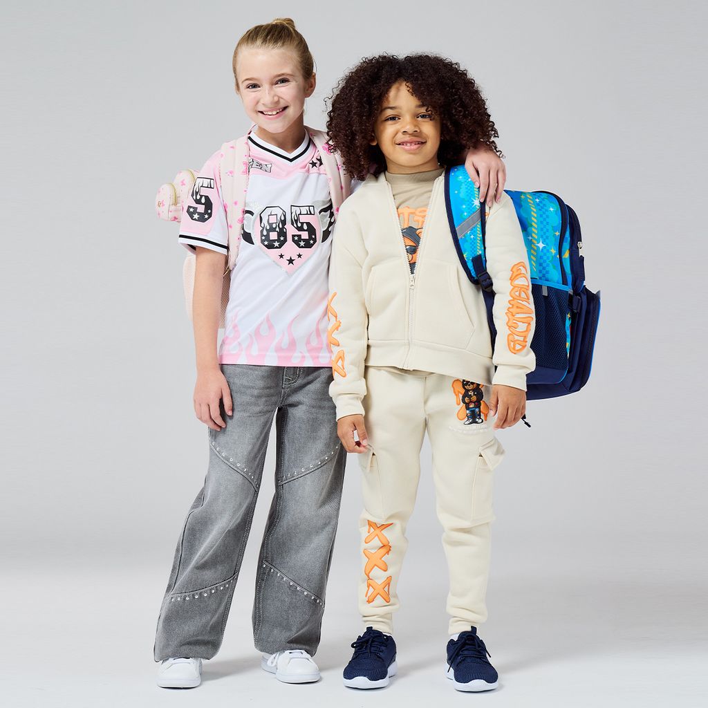 Two kids with school clothing and backpacks on