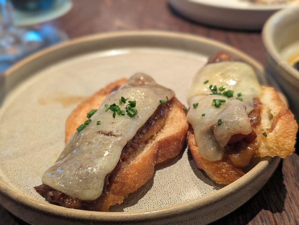 Oxtail montadito: braised oxtail with melted mahon cheese on crostini at Rojo by Razzle Dazzle