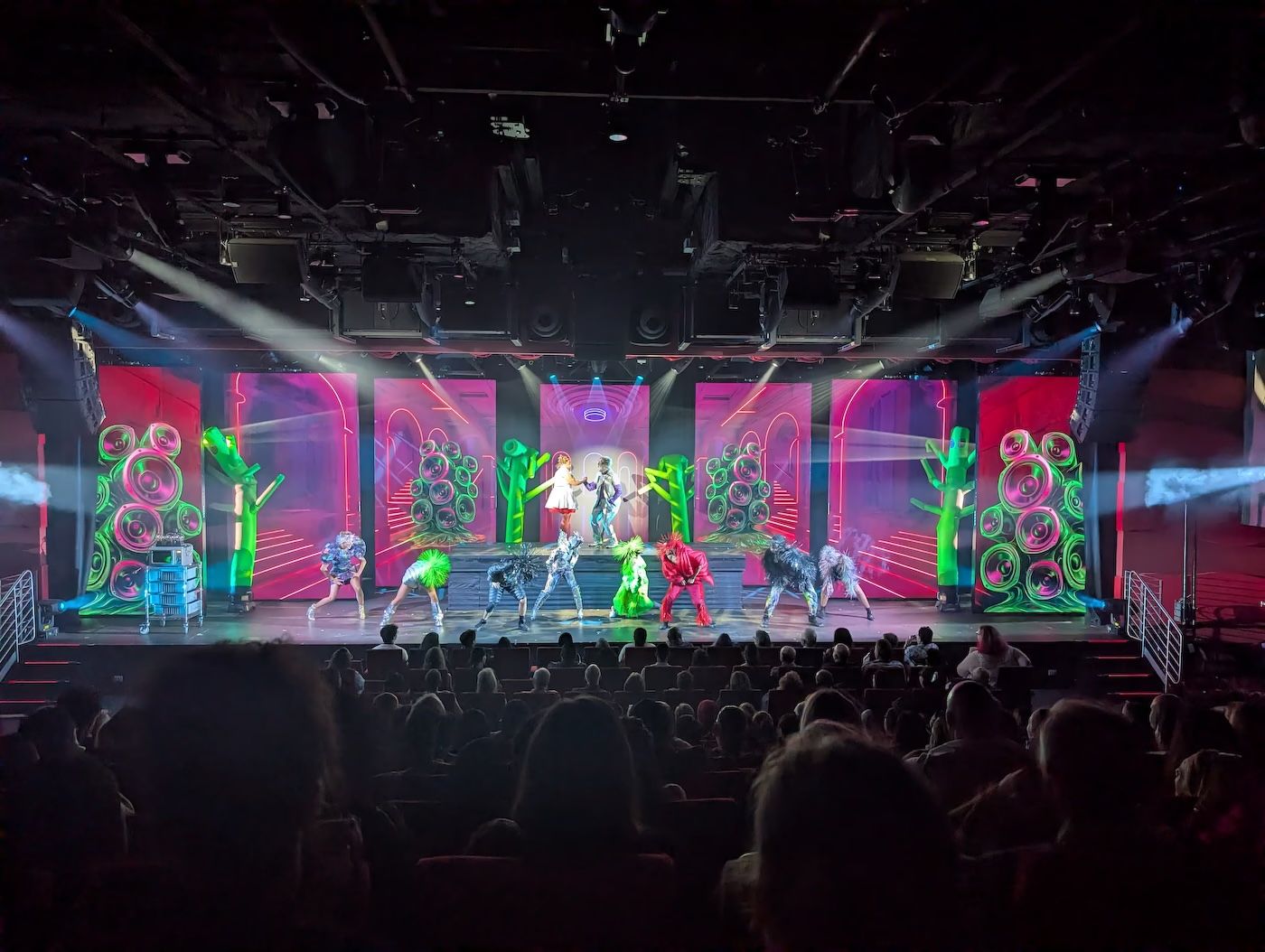 Out of Time production show on stage in The Red Room with neon set pieces and dancers