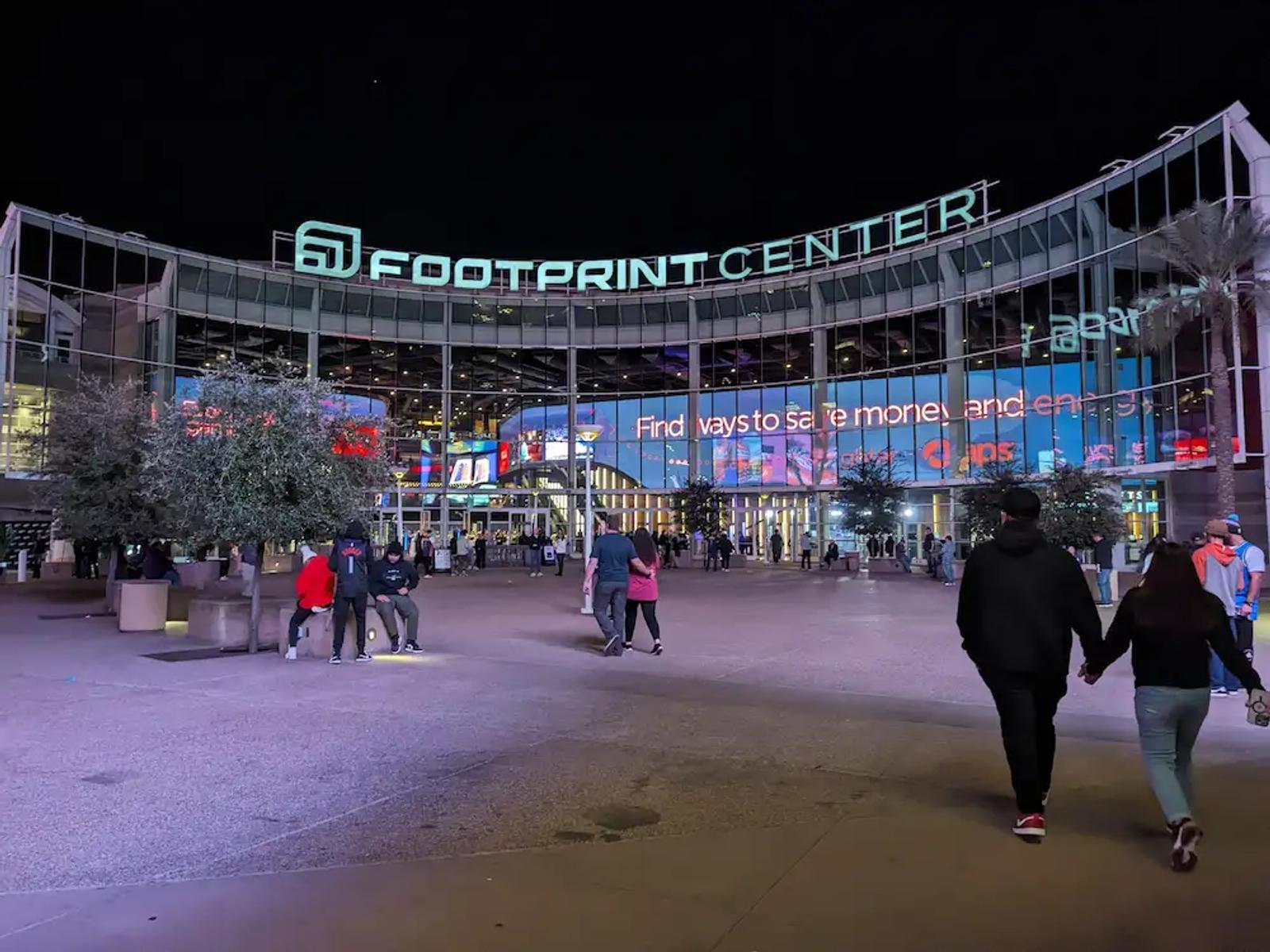 Walking up to the Footprint Center in Phoenix for a Suns game at night.