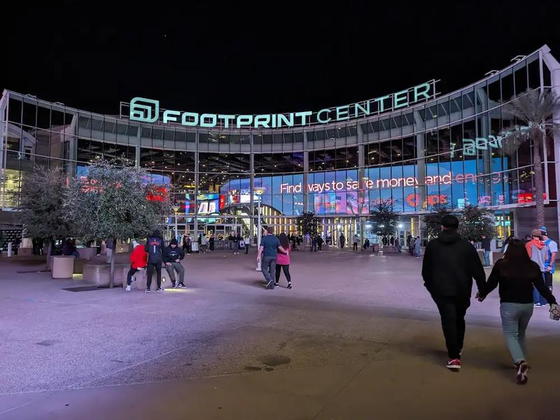Walking up to the Footprint Center in Phoenix for a Suns game at night.