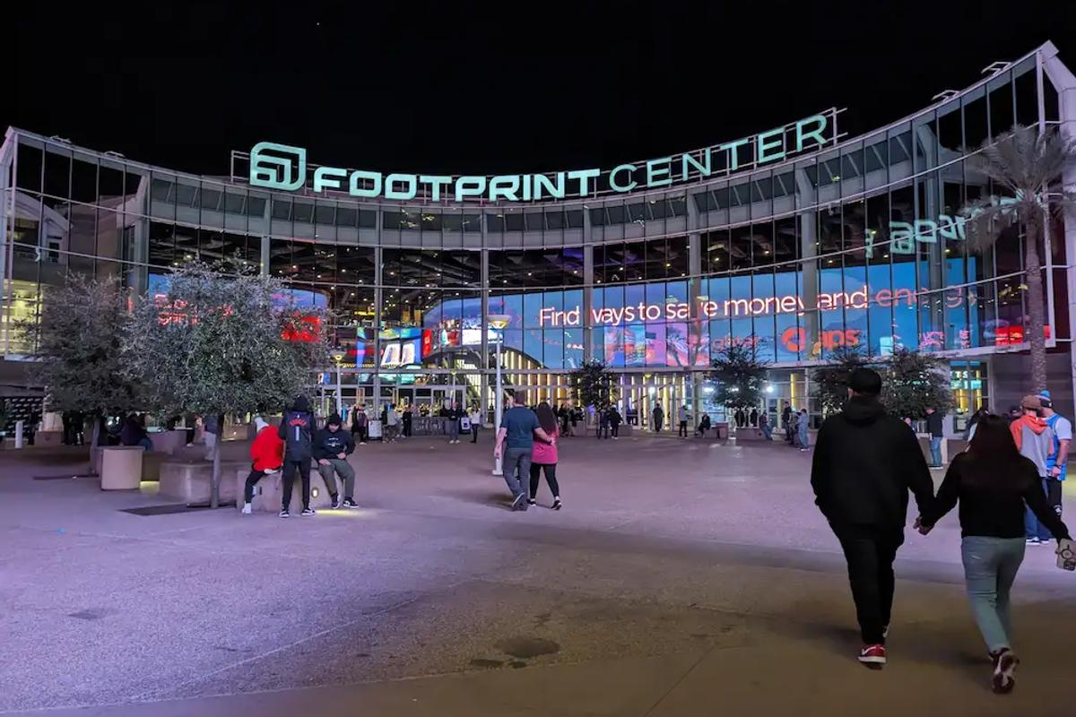 Walking up to the Footprint Center in Phoenix for a Suns game at night.