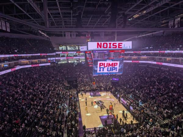 High-up view of the Sacramento Kings game at Golden 1 Center with the crowd cheering and the scoreboard lit up.