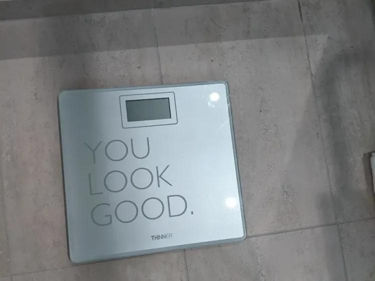 Glass bathroom scale on a tile floor with the words you look good printed on it at the Grand Hyatt at SFO.