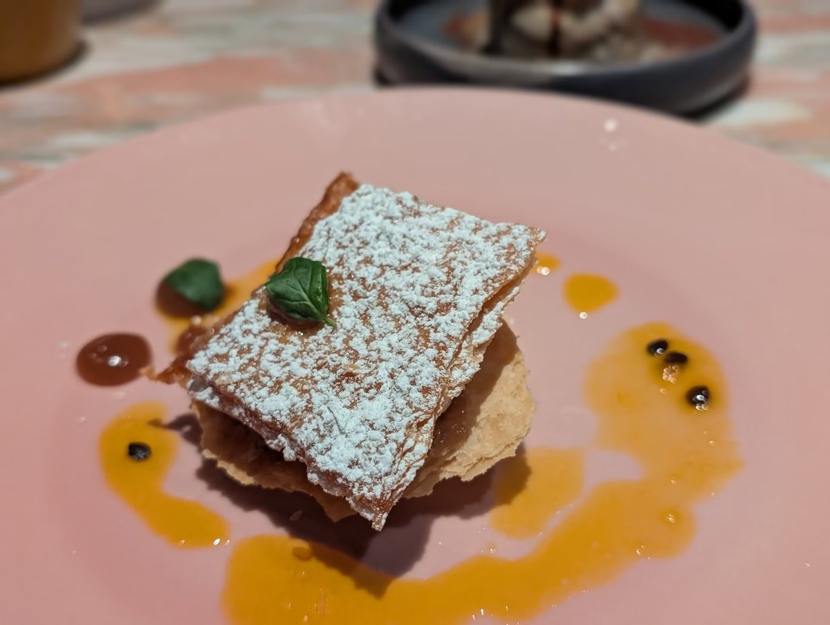 Milhojas: layered puff pastry dusted with sugar, with caramel and passion fruit sauce at Pink Agave