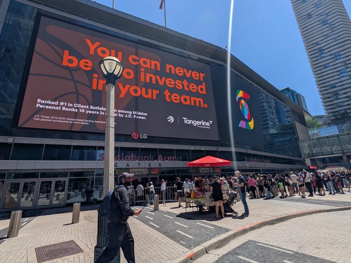 Outside Scotiabank Arena in Toronto. A big Tangerine ad on the wall and a long line of fans waiting at Gate 6.