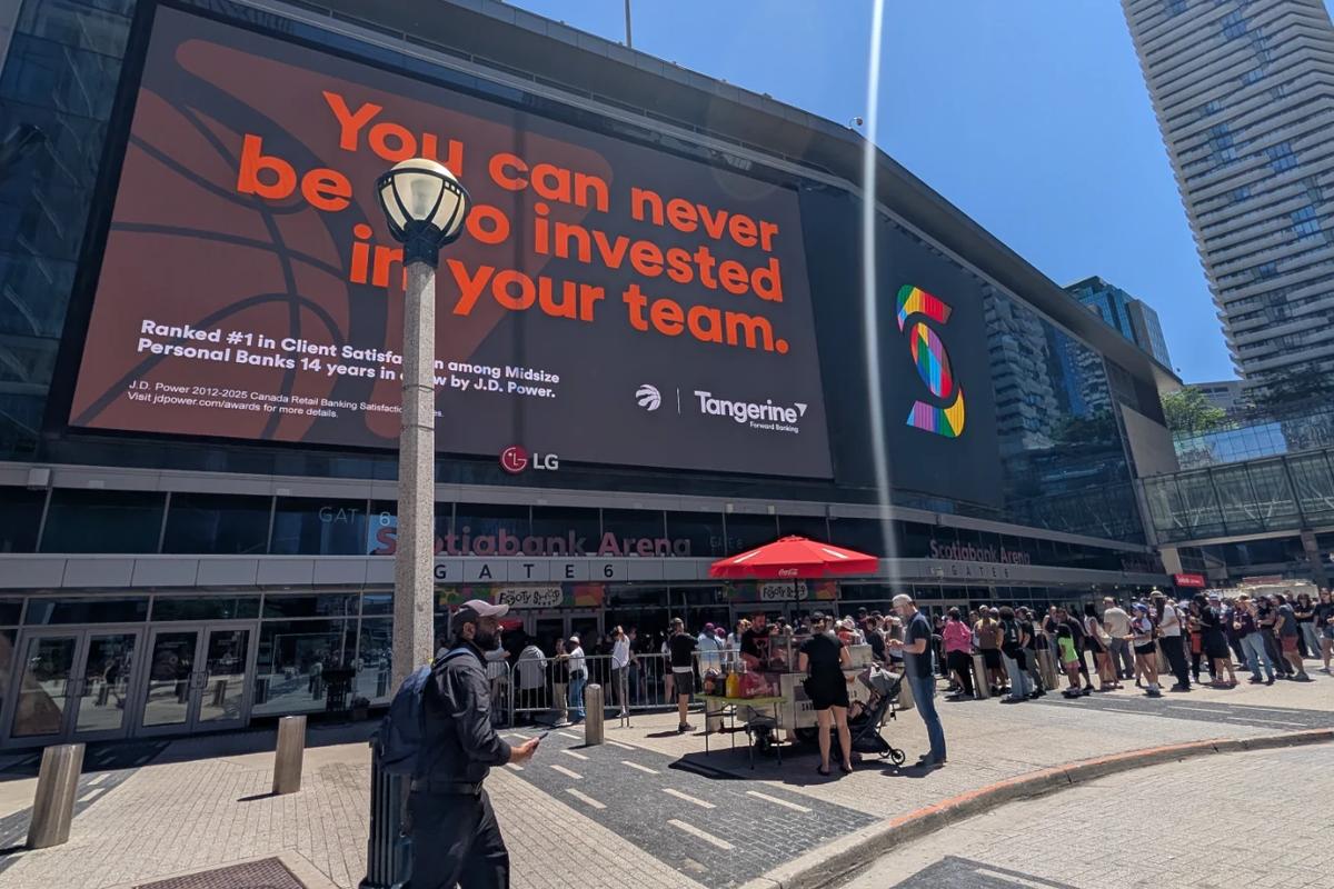 Outside Scotiabank Arena in Toronto. A big Tangerine ad on the wall and a long line of fans waiting at Gate 6.