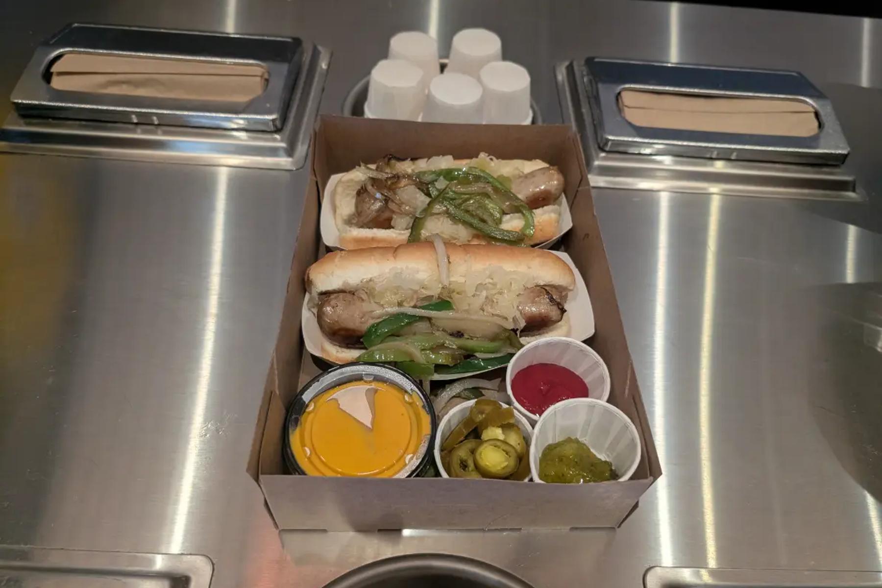 Sausages topped with peppers