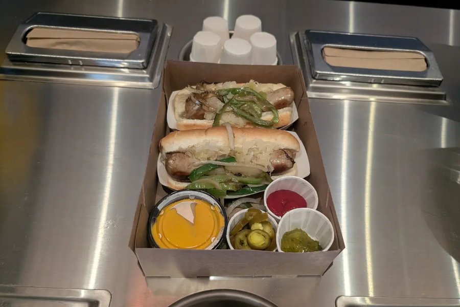 Sausages topped with peppers