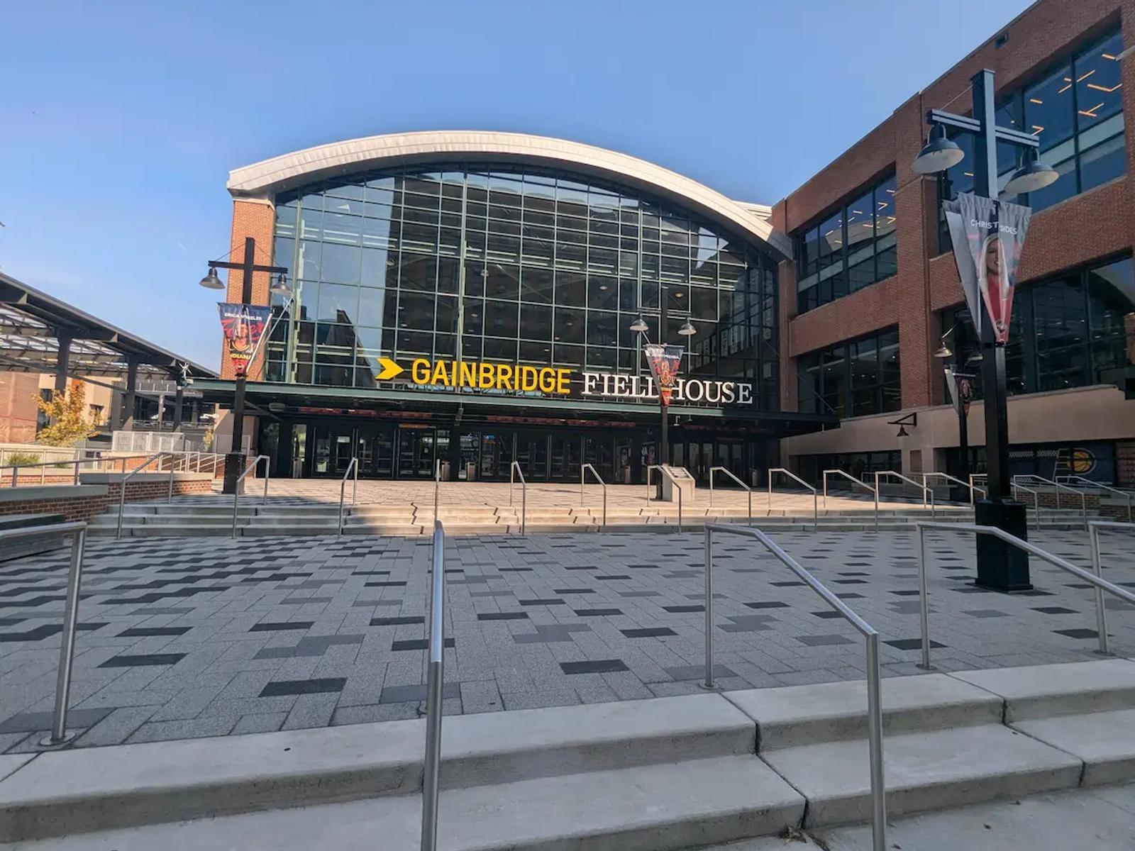 The main entrance to Gainbridge Fieldhouse in Indianapolis on a sunny day.