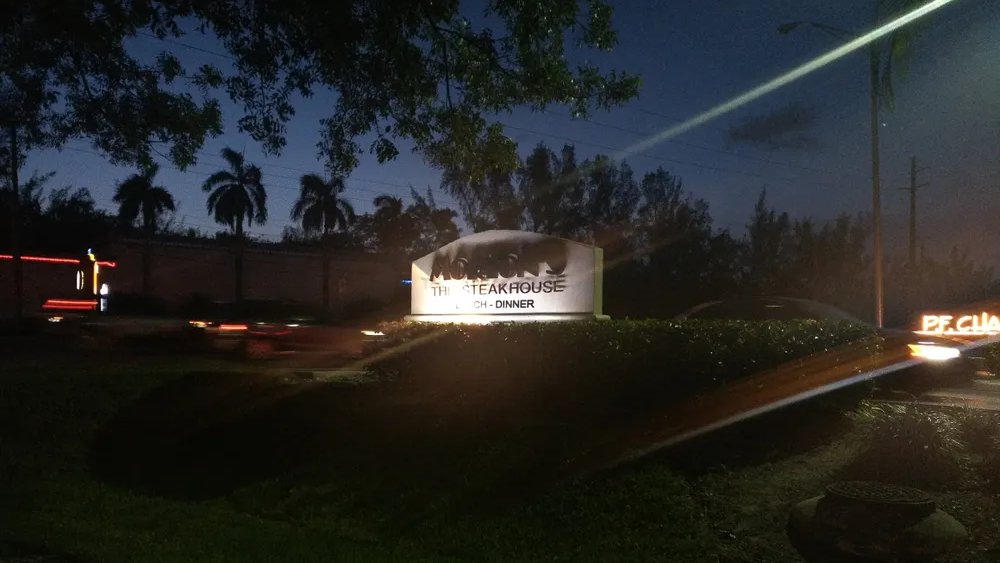 The illuminated Morton's The Steakhouse sign at night in North Miami Beach.