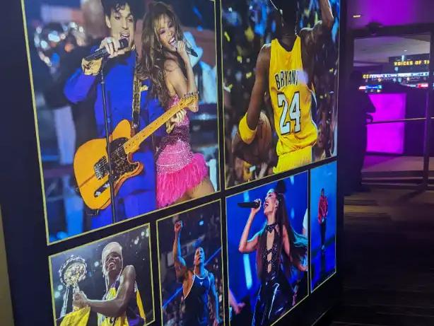 Wall of photos at Crypto.com Arena in LA, highlighting legendary Lakers moments and performers.
