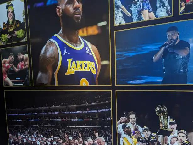 Wall of fame at Crypto.com Arena in LA, with photos of LeBron, Taylor Swift, Drake, and championship teams.