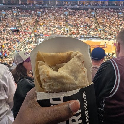 Snacking on a Caribbean roti while watching the WNBA game at Scotiabank Arena in Toronto.