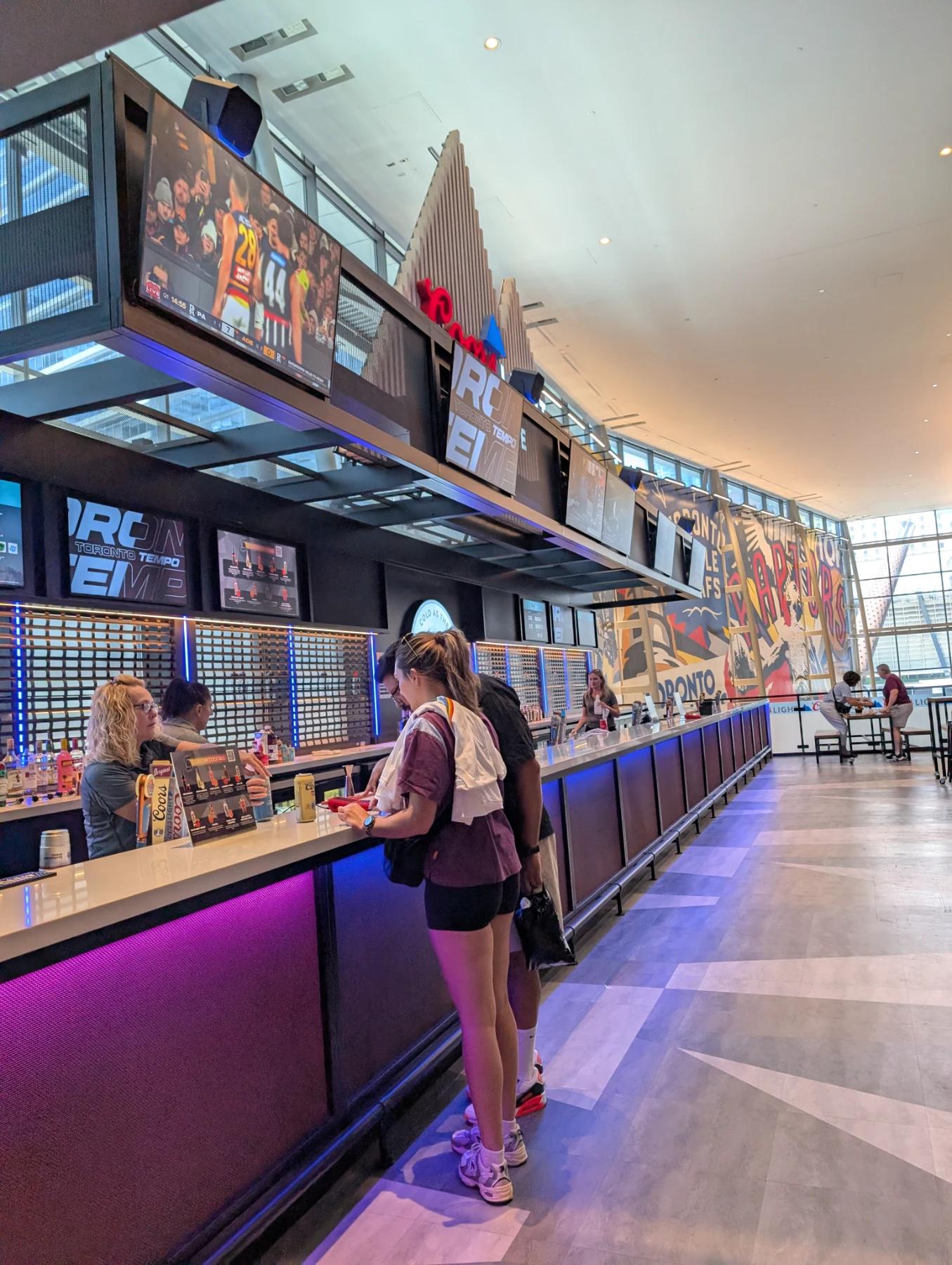 Ordering drinks at the Toronto Tempo bar inside Scotiabank Arena before the game.