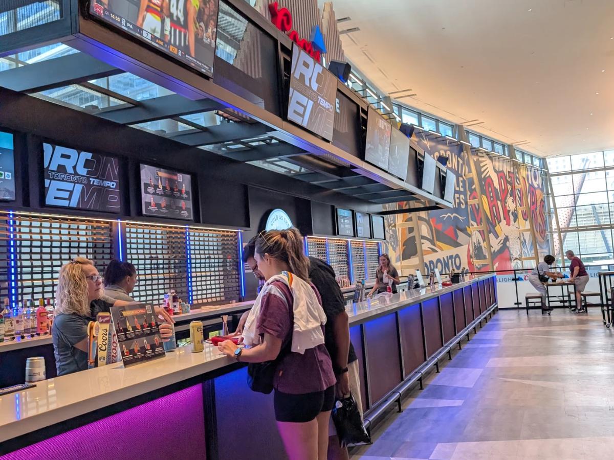 Ordering drinks at the Toronto Tempo bar inside Scotiabank Arena before the game.
