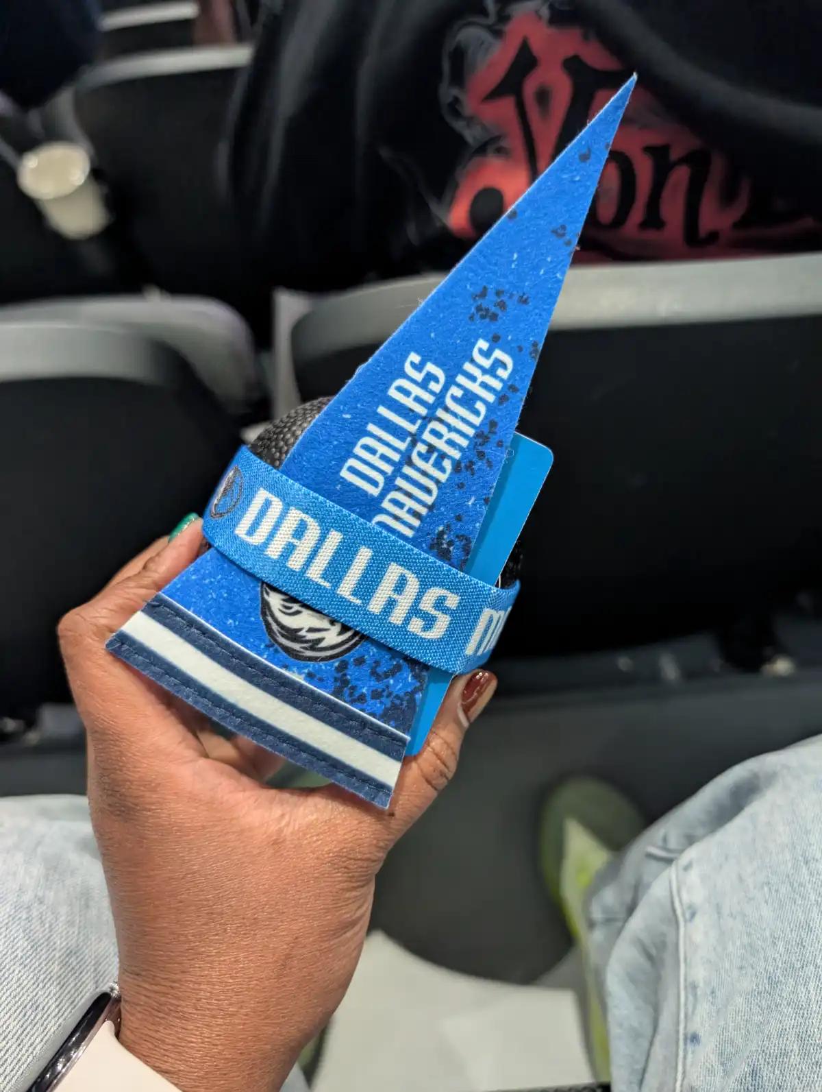 Holding a Dallas Mavericks pennant and souvenir wristband at the American Airlines Center.