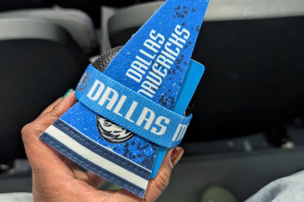 Holding a Dallas Mavericks pennant and souvenir wristband at the American Airlines Center.
